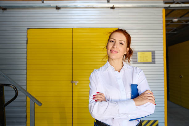 istock Female with a blue folder stands at the yellow door 1765467982