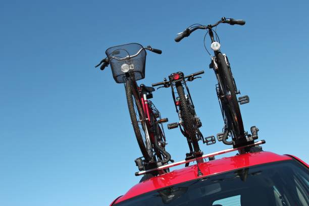 istock bicycle rack on top of red car 1765467990