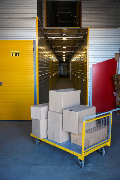 istock Cargo trolley on small wheels stands near the containers 1765469155