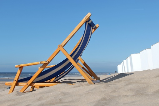 Sunbeds on a beautiful beach with gold sand. Concept for vacations or tourism