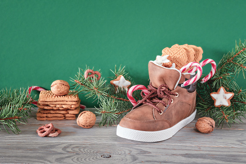 St Nicholas Day or Nikolaus, German holiday, December 6. Children shoes with traditional sweets.
