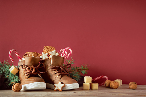 Saint Nicholas Day or Nikolaus, german holiday, December 6. Children shoes with traditional sweets.
