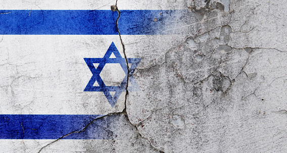 Painted Israel flag peeling off distressed plaster wall
