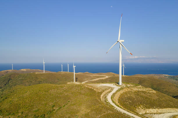 istock Electrical wind turbines in mountains on sea coast 1765500614
