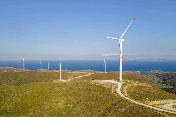 istock Electrical wind turbines in mountains on sea coast 1765500621