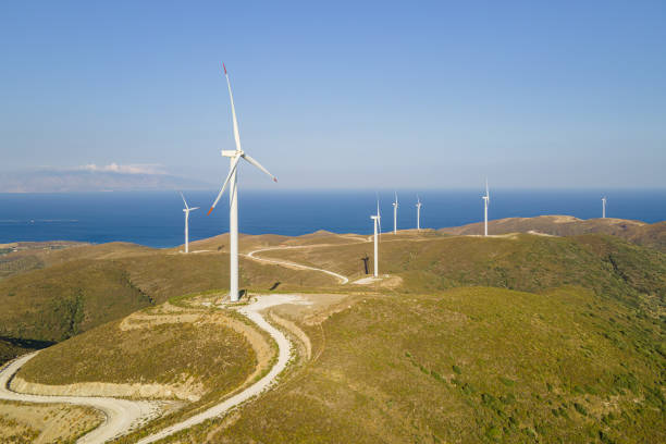 istock Electrical wind turbines in mountains on sea coast 1765500656