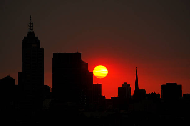 istock Big red summer sun over city silhouette 176550782