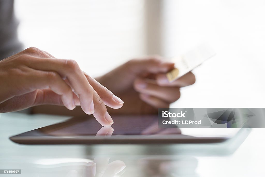 Woman shopping using tablet pc and credit card Internet shopping online.indoor.close-up Digital Tablet Stock Photo