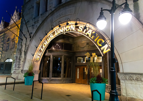 Union Station, St. Louis, MO - USA: Oct. 21, 2023 - Lighted entryway of historic Union Station in St. Louis at night. St. Louis Union Station spelled out in illuminated letters. Side view.