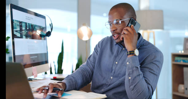 istock Businessman, notes and phone call for research in office, working and discussion on proposal, report and project. Black person, internet and conversation on agenda, contact us and information in plan 1765529398