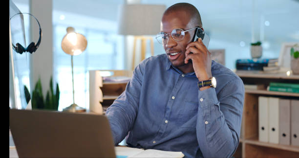 istock Businessman, working and phone call in office, discussion and conversation on proposal, report and project. Black person, talking and planning on laptop, corporate and schedule for agenda on tech 1765529402