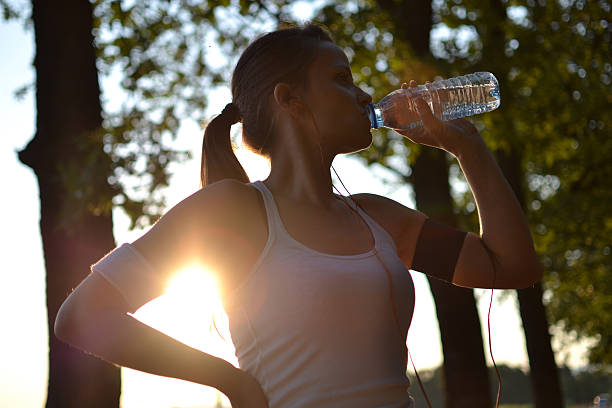 istock young woman drinking water 176554171