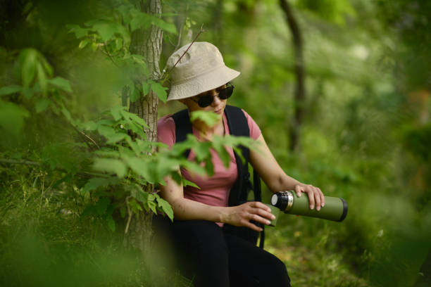 istock young lady walking in the forest 1765556567