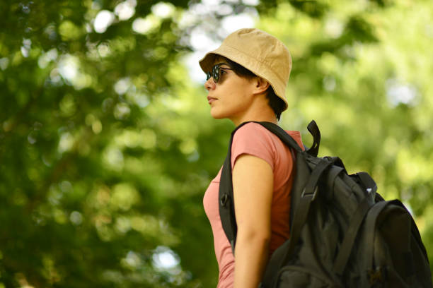 istock young lady walking in the forest 1765557693