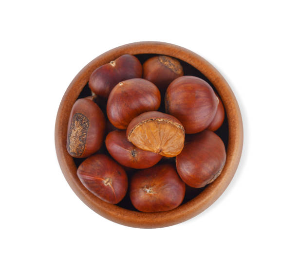 istock Chestnuts in a wooden bowl isolated on white 1765564786