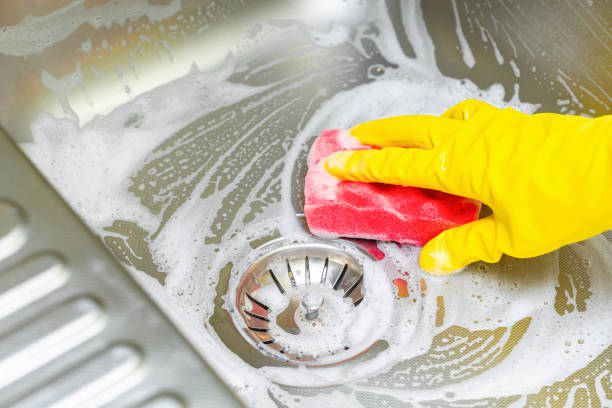 istock hand in a yellow glove washes a kitchen sink with a sponge 1765570390