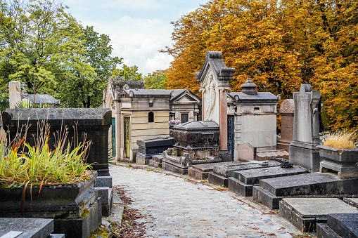 Paris, the Pere-Lachaise cemetery, cobbled alley with graves in winter