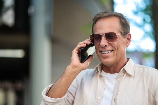 istock Man posing on street and looking talking by his phone. 1765582965