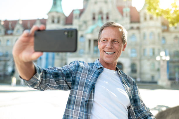 istock Man making selfie with city on background. 1765582985