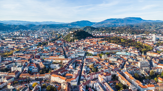Aerial evening view of the city of Graz with the city centre and the landmark Schloßberg in the background
