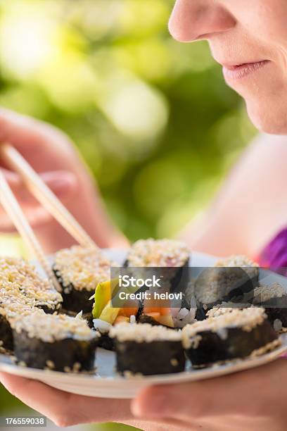 Young Woman Eating Sushi Stock Photo - Download Image Now - 20-24 Years, Adult, Adults Only