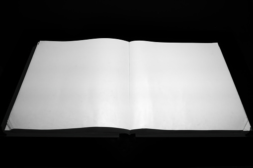 White sheets of book. Open book on a black background. Paper book. Mock up. Space for text.