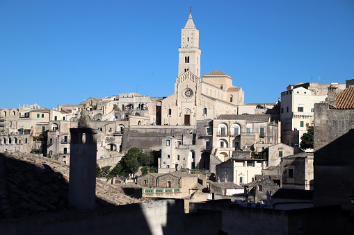 Some cherries in bloom create a suggestive and idyllic view of Piazza del Gesù, in the medieval heart of the ancient city of Viterbo, in central Italy. The medieval center of Viterbo, the largest in Europe with countless historic buildings, churches and villages, stands on the route of the ancient Via Francigena (French Route) which in medieval times connected the regions of France to Rome, up to the commercial ports of Puglia, in southern Italy, to reach the Holy Land through the Mediterranean. Located about 100 kilometers north of Rome along the current route of the Via Cassia, Viterbo is also known as the city of the Popes, because in the 13th century it was the Papal See for 24 years. Super wide angle image in 16:9 and high definition format.