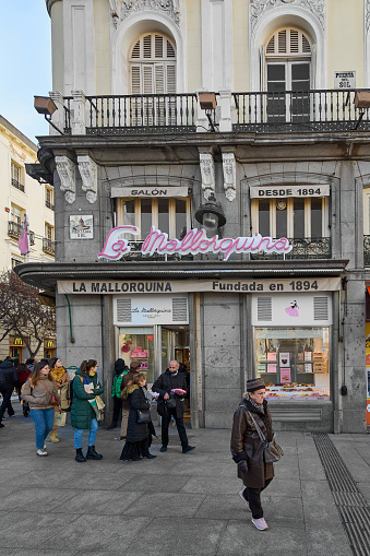 Madrid Spain - october 30, 2023: facade of la mallorquina, a pastry shop founded in 1894 in Madrid, Spain. the image has different types of people passing in front of the establishment.