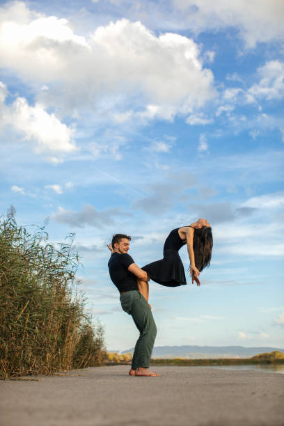 istock Young man and woman doing acroyoga 1765611012