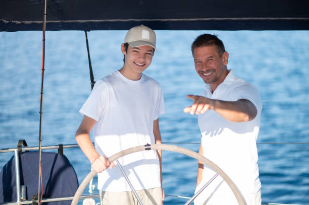 istock Dad showing his son how to manage the boat 1765611602