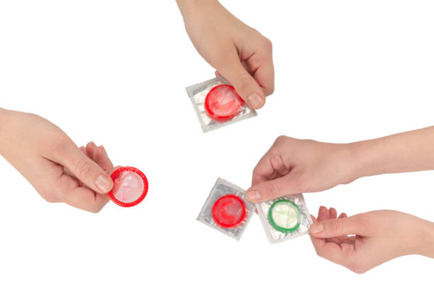 istock Condom in woman hand isolated on white background. 1765612728