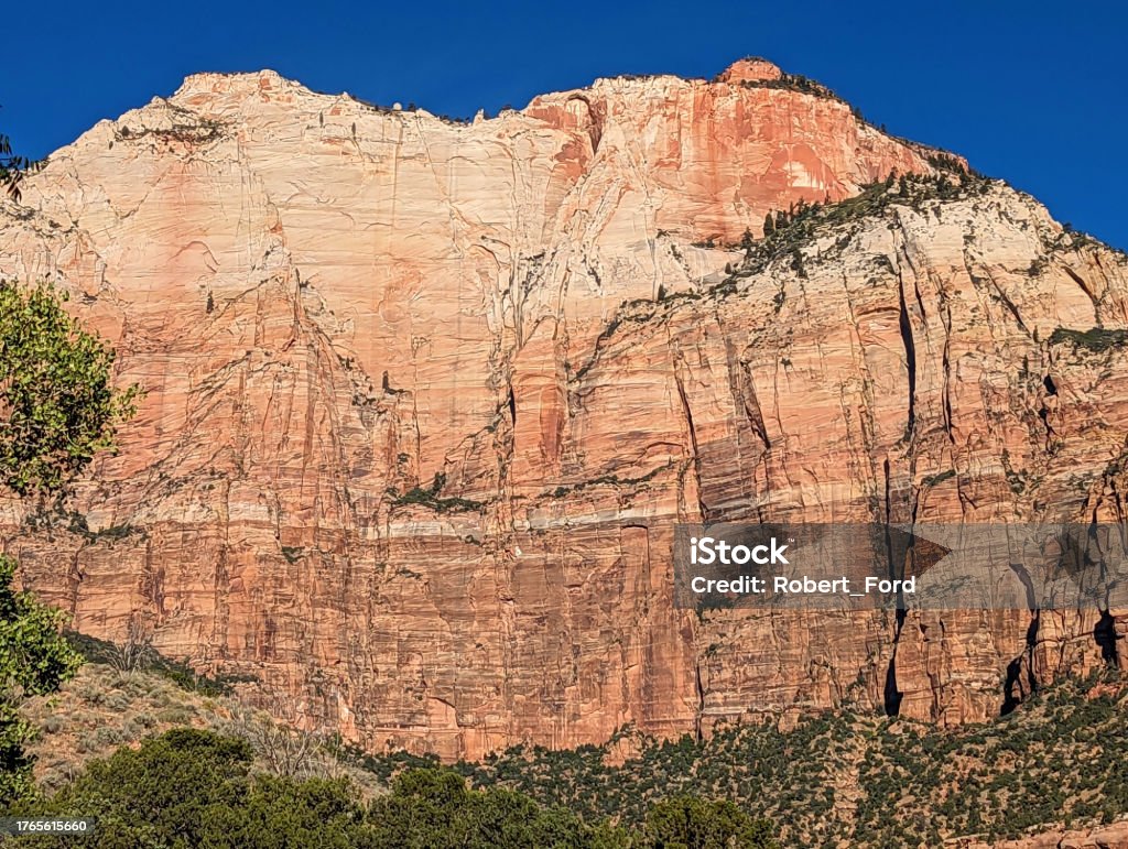 Sandstone cliffs of Zion Canyon at the Community Center and Public Library in Springdale Utah with backdrop of  Zion National Park Cliff Stock Photo