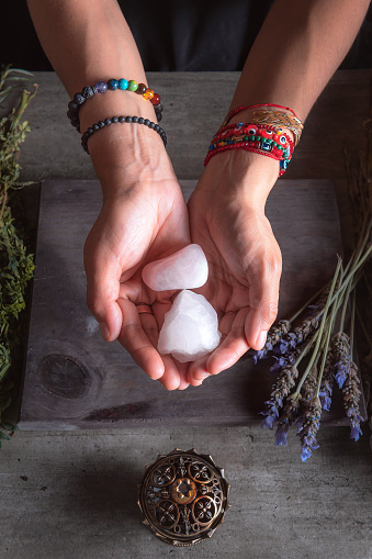 woman holding rose quartz with her hands for spiritual and traditional ritual of the Latin American region or in Mexico