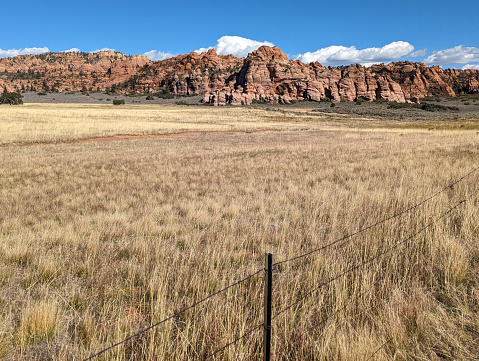 Dry pastures and red rock hoodoos along Kolob Terrace Road near Smith Mesa and Cave Valley in Zion National Park Utah