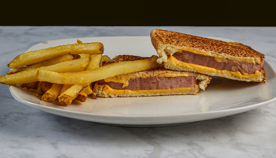 spam melt sandwich served with a side of fries