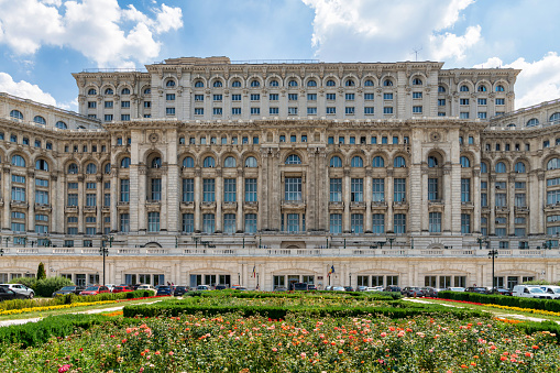 Moscow, Russian Federation - August 27, 2017 : Located in Theatre Square a view of The Bolshoi Theatre surrended by flowers with many people and tourists walking in a sammer day.