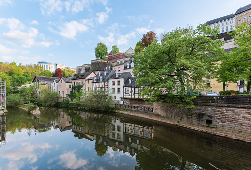 View of Grund, Luxembourg the ancient pastel houses reflecting in the river Alzette in Luxembourg old town, UNESCO World Heritage Site and the ancient city wall