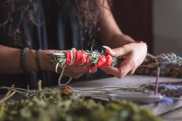 istock woman doing traditional ritual with herbs tying them with cotton thread accompanied by incense 1765630527