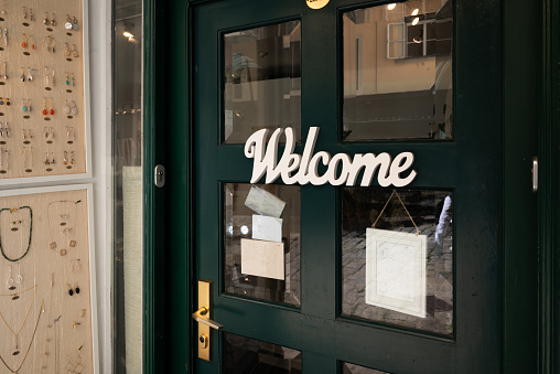 Welcome sign on door of a small boutique store