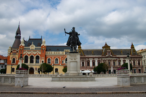 Piata Unirii ( Union Square ) with beautiful buildings and the statue of King Ferdinand I on a summer afternoon in Oradea, Bihor County, Romania