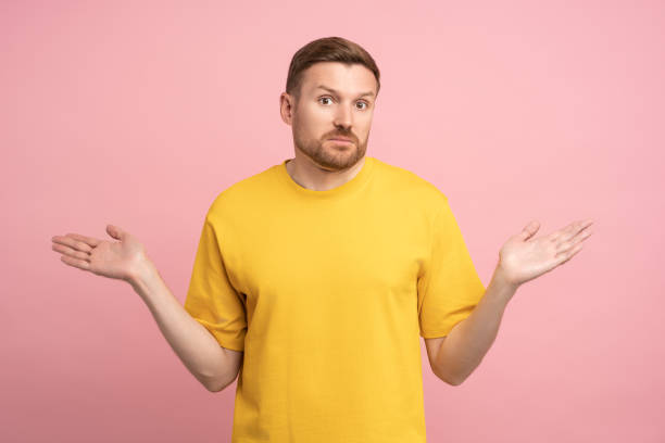 istock Confused man spreading hands shrugging shoulders what happened no idea solution, studio background. 1765677606