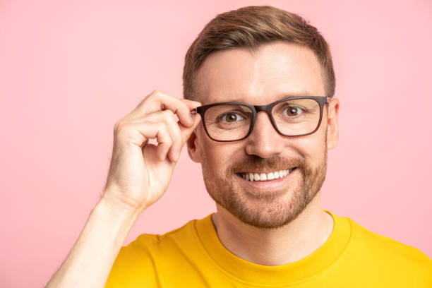 istock Friendly cheerful middle-aged unshaved man touching glasses and looking at camera pleasantly smiling 1765677639