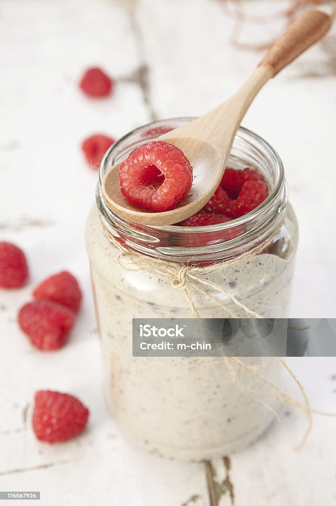 Mason jar of oatmeal with fresh raspberries on white table Oatmeal smoothies with berry Oatmeal Stock Photo