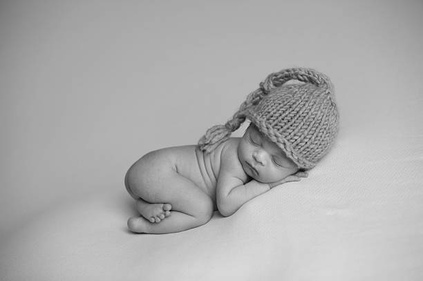 istock African American Newborn Sleeping on Blanket Wearing Knit Hat 176568398