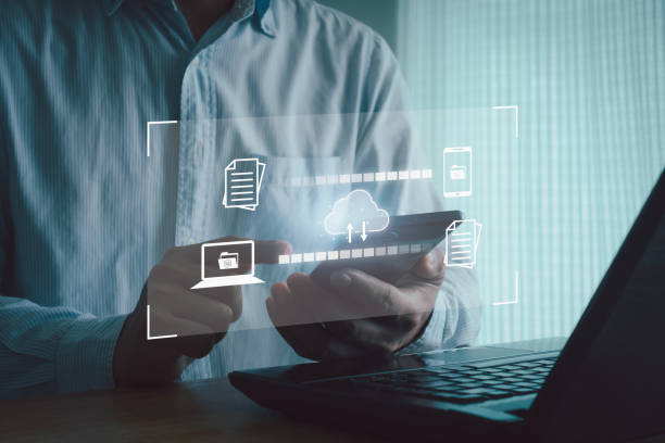 istock Data transfer concept to a server or hosting service. Business people use smartphone and laptop computer to document file transmission cloud database network technology. Business digital marketing. 1765689183