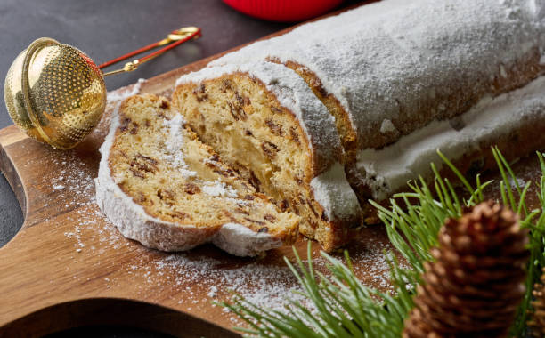 istock Christmas pastries stollen sprinkled with powdered sugar on the table, festive dessert 1765708166
