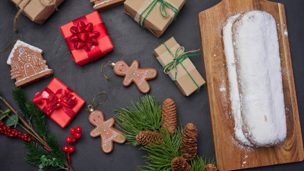 istock Christmas pastries stollen sprinkled with powdered sugar on the table, festive dessert 1765709811