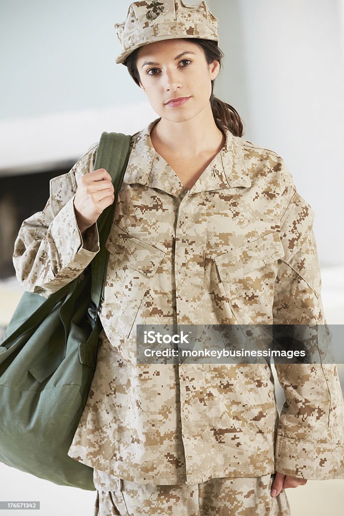 Female Soldier With Kit Bag Home For Leave Female Soldier With Kit Bag Home For Leave Looking To Camera Leaving Stock Photo