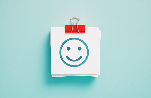 Happy smiley face emoticon on white background