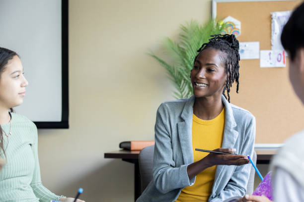 istock A high school teacher takes the lead in a group discussion with her students 1765738852